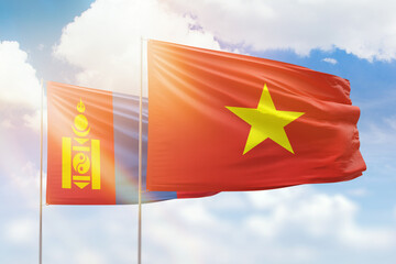 Sunny blue sky and flags of vietnam and mongolia
