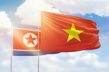 Sunny blue sky and flags of vietnam and north korea
