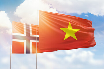 Sunny blue sky and flags of vietnam and norway