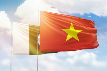 Sunny blue sky and flags of vietnam and pakistan