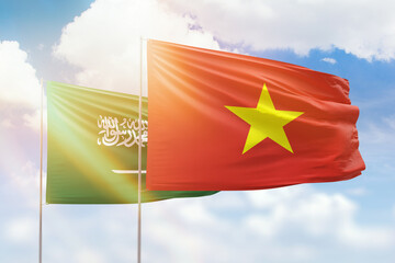 Sunny blue sky and flags of vietnam and saudi arabia
