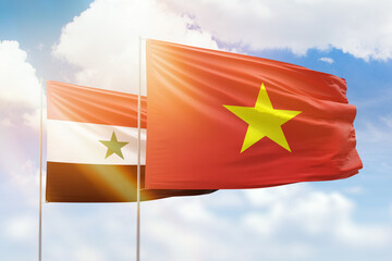 Sunny blue sky and flags of vietnam and syria