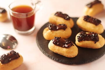 Traditional French dessert - eclairs with a cup of coffee