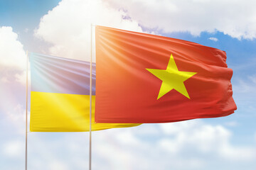 Sunny blue sky and flags of vietnam and ukraine