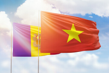 Sunny blue sky and flags of vietnam and andorra