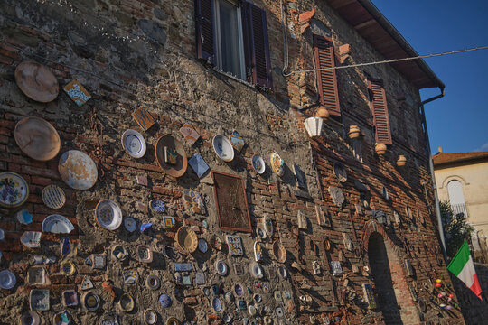 Plates on a wall in Italian village street