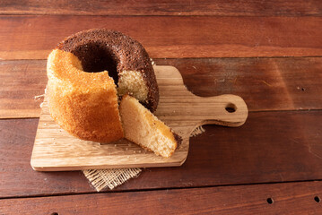 Wooden table with typical Brazilian Festa Junina foods. Cake