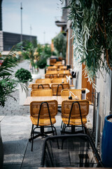 Flowers and dish on a wooden table in a outdoor restaurant on a sunny day