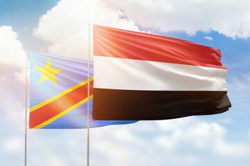Sunny blue sky and flags of yemen and dr congo