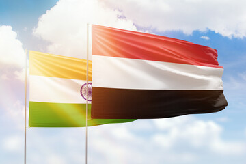 Sunny blue sky and flags of yemen and india