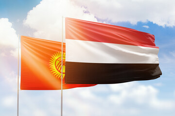 Sunny blue sky and flags of yemen and kyrgyzstan