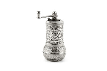 Antique silver metal pepper mill with arabic pattern on white backround