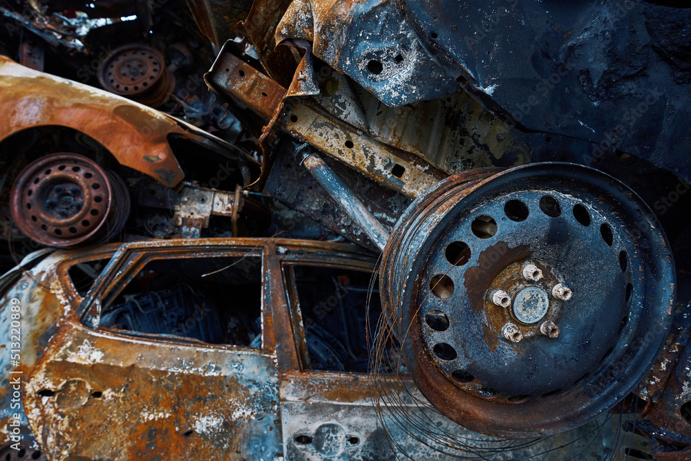 Wall mural Charred remains of vehicles after military attack in Irpin