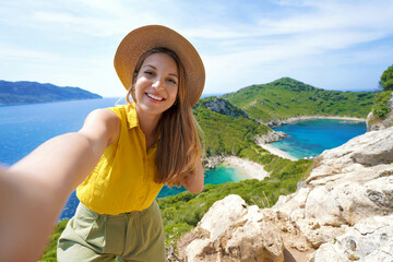 Young traveler woman taking selfie picture from Porto Timoni Viewpoint in Corfu, Greece