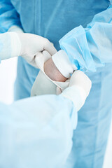 Fototapeta premium Medical workers wearing protective clothes before the operation