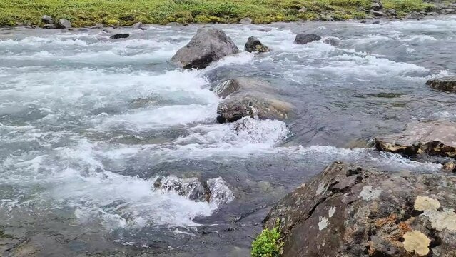 Fantastic landscape with flowing rivers and streams with rocks and grass in Iceland.