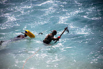Snorkelers Exploring the Ocean with Spear Guns and Spearfish Hunting 