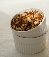  white ceramic cups with granola on half shadow 