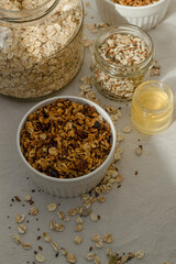 Cereals, seeds and honey in the jars, granola in the mug