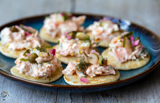 Party canapes, blinis with salmon spread