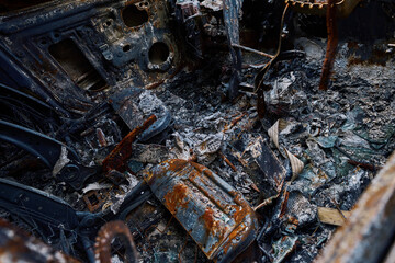 Burned interior of car cabin, exploded from Russian shelling