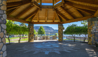 Beautiful wooden gazebo recreation area at lakeside in public park. Summer pergola in a park. Public exterior
