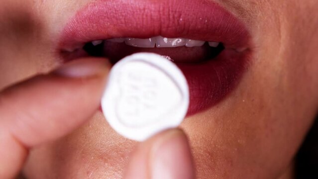 A pill on a woman's tongue