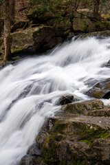 A stream cascades down over rocks.