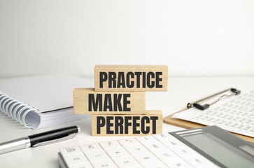 Top view of Practice Makes Perfect words on wooden cube