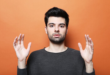 lifestyle, emotion and people concept: portrait of a young man surprised face expression, close up