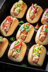 Fresh and tasty mini hot dogs with various toppings.