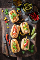 Hot and homemade mini hot dogs with various toppings.