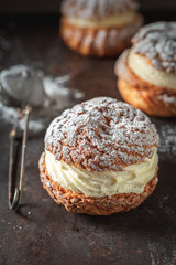 Hot and sweet cream puffs with sugar and vanilla cream.