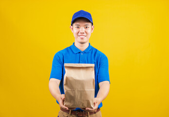 Portrait excited delivery service man smile wearing blue t-shirt and cap uniform hold paper...
