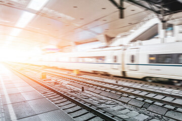 High speed fast train passenger locomotive in motion at the railway station city