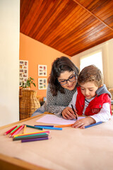 Mom Helping Young Son to Draw. Happy Family Moment while Learning New Things.
