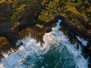 Rough ocean water around the rocky coastline.
