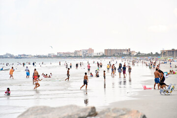 Tourists and local families enjoying a beach day at Jetty Park in the port at Cape Canaveral on the Space Coast of Central Florida
