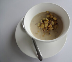 Coconut water lotus seed in white cup, white background, top view: Thai dessert, very tasty, nourishing the body.