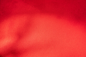 Close up of red fabric texture and shadow for background and texture.