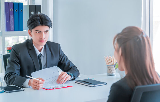 HR officer is interview a female candidate and reading resume for coperation employment concept.