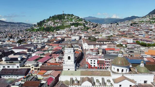 Quito, Ecuador: Aerial drone footage of the famous Quito colonial historic district with the San Francisco square and basilica with the  El Panecillo hill and statue.  Shot with a forward motion. 
