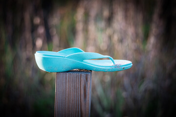 flip flop on a wooden post