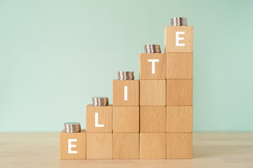 エリートのイメージ｜「ELITE」と書かれたブロックとコイン