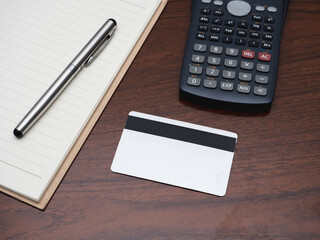 Credit card with calculator workspace on table top view