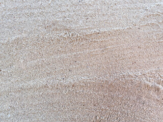 Closed up sand on the ground at the beach. Rough surface texture in nature.