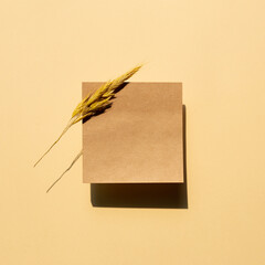 Blank sticky note pad isolated on beige background. top view, copy space