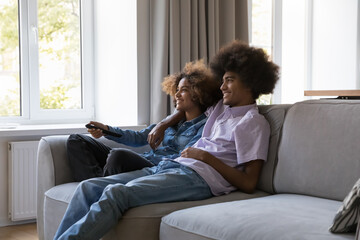 Teen-age African couple spend weekend switch channels, watch favourite TV show series or movie...