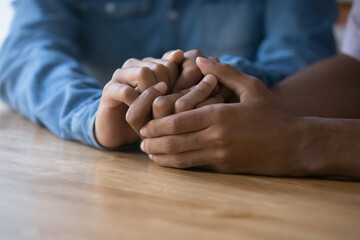 Close up African couple holding hands, demonstrate support, express trust, say sorry. Family...