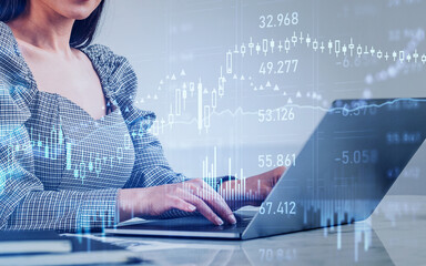 Businesswoman working with laptop, forex diagrams and financial chart